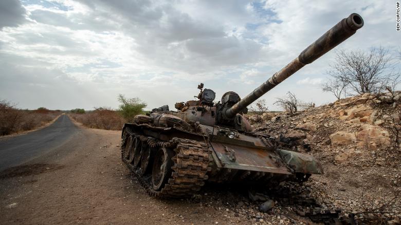 Nigerian military tank on rural road symbolizing technological progress.