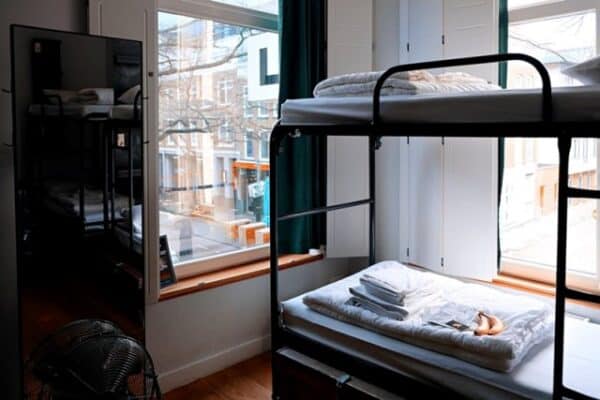Modern student dorm room with bunk beds and large windows in South Africa.