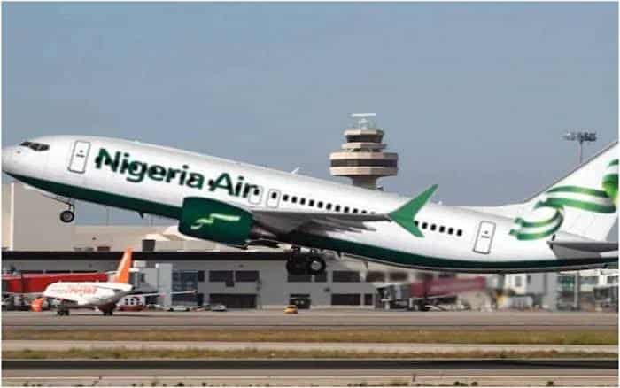 Nigeria Airplane in flight during takeoff at airport runway.