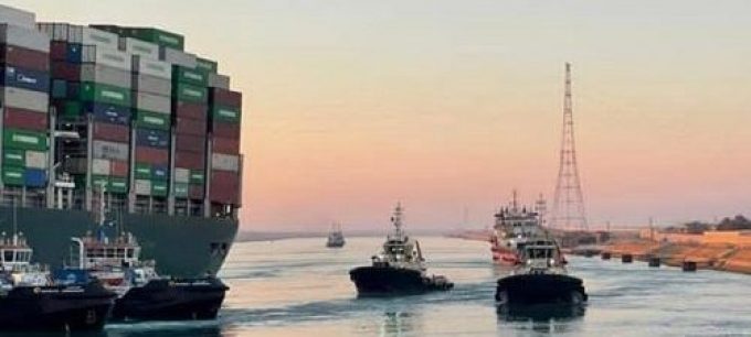 African port with cargo ships and tugboats facing potential economic challenges.