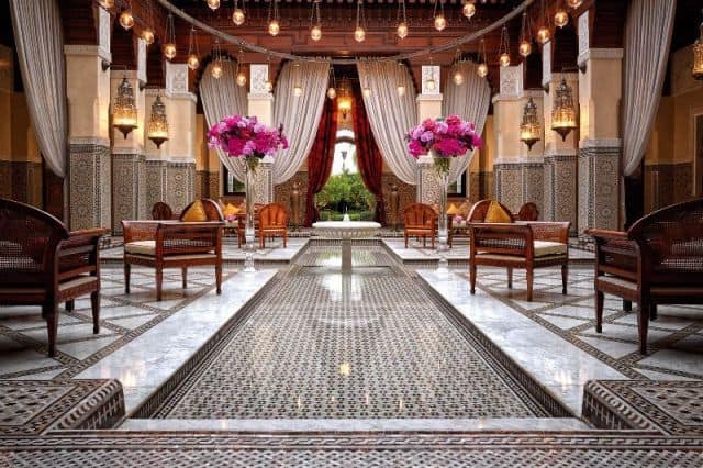 Elegant hotel lobby with ornate decor and vibrant floral arrangements in Africa.