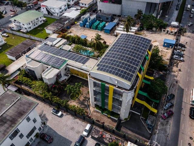 Solar-powered building with rooftop panels supporting Africa’s renewable energy efforts.