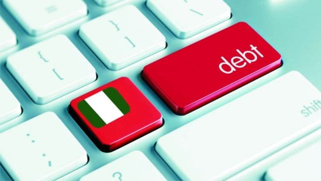 Close-up of a keyboard with Uganda flag and debt key, symbolizing smuggling issues.