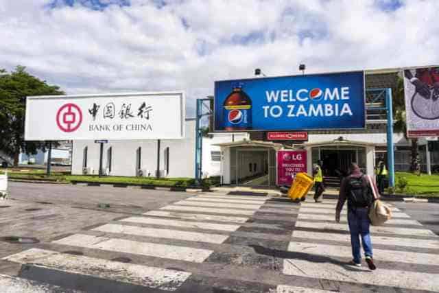 Bank of China sign at Zambia border with welcoming signage for travelers.