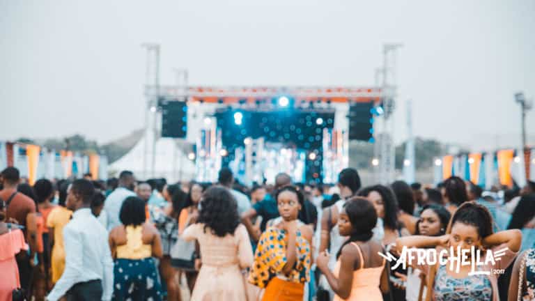 Vibrant African music festival with diverse crowd and stage lighting.