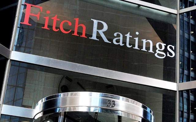 Fitch Ratings logo on a modern office building exterior.