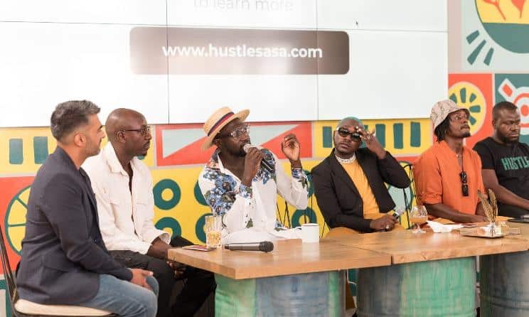 Panel of diverse entrepreneurs discussing business strategies at Africa.com event.