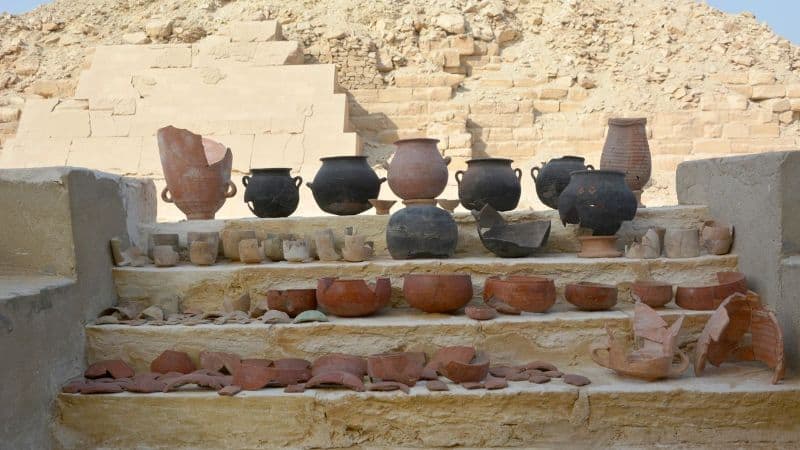 Collection of ancient Egyptian pottery and substances used in mummification processes.