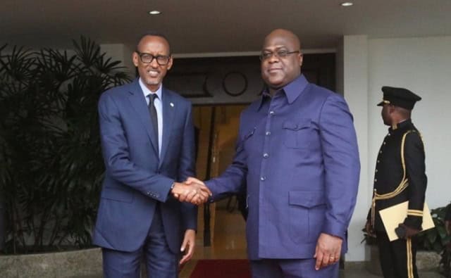 African leaders shaking hands at a formal event.