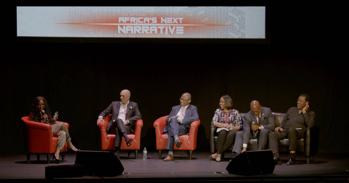 Heritage enthusiasts on stage discussing tombstones and mausoleums at a cultural event.