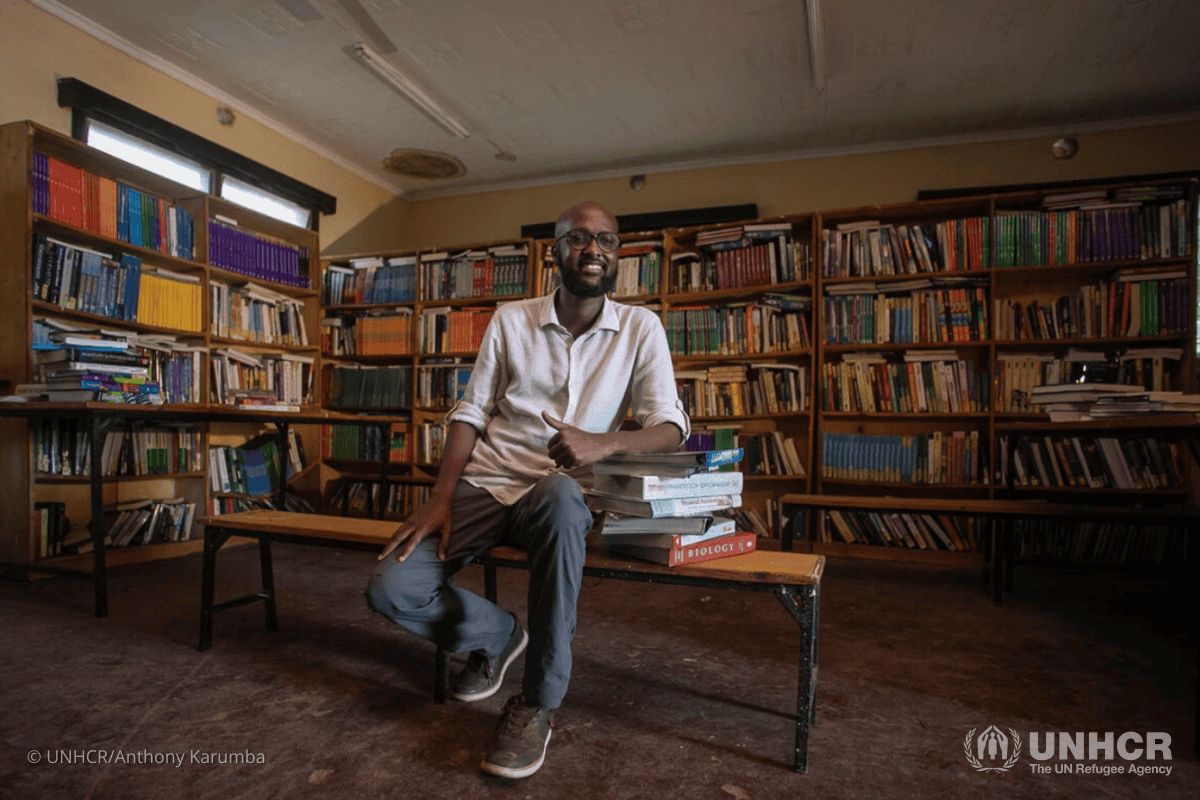 Man exploring African tribe history in a library setting for immersive VR experience.