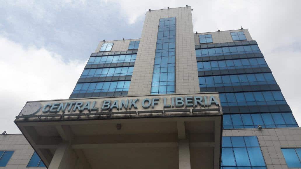 Modern high-rise building of the Central Bank of Liberia with glass facade.