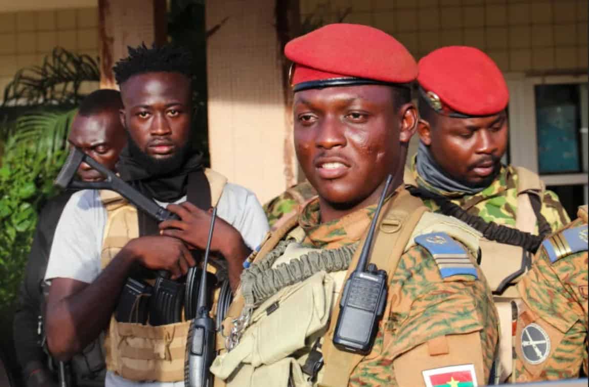 African soldiers in uniform with serious expressions, possibly in a security or military operation.