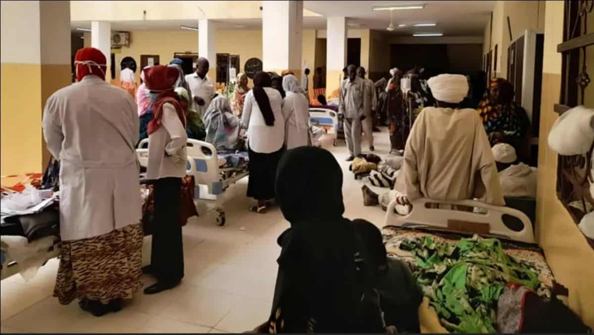 Crowded hospital ward with patients and healthcare workers in Nigeria.