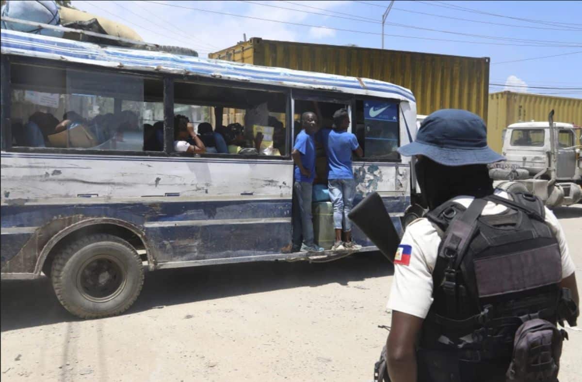African police officer monitoring public transportation scene.