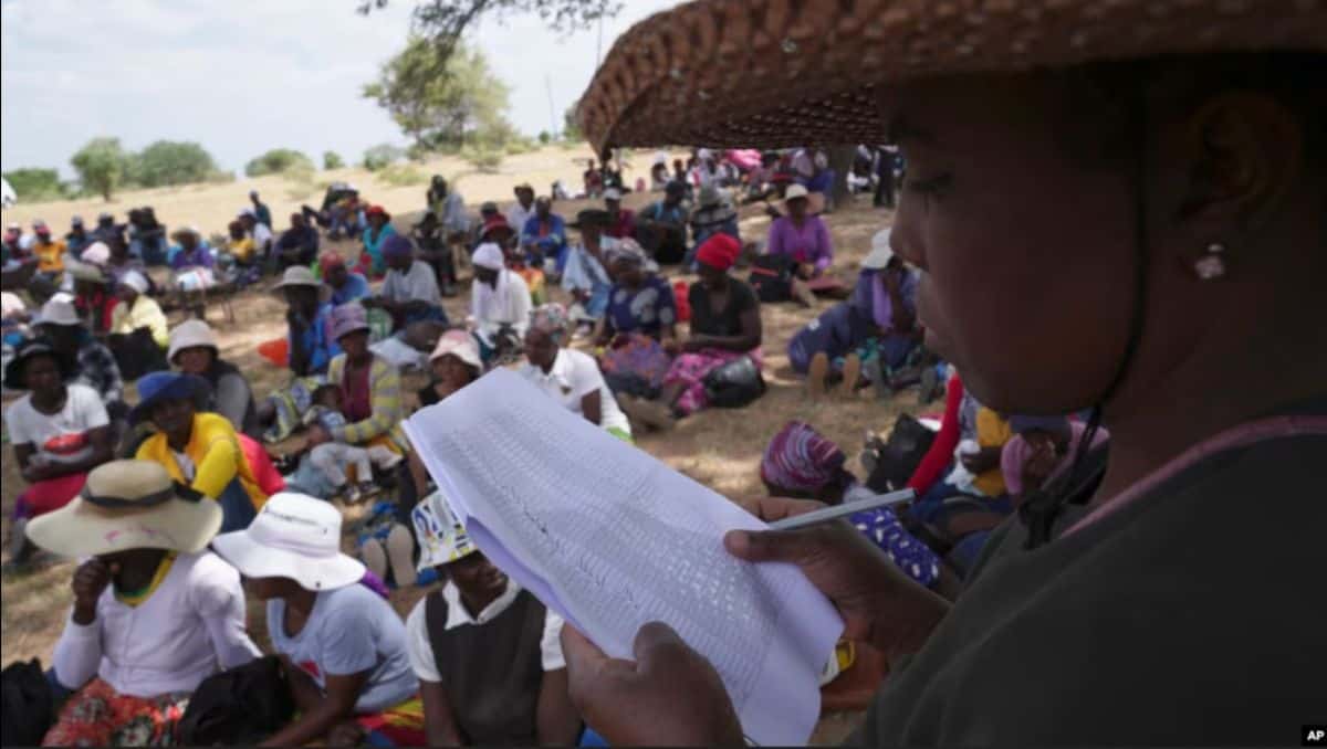 Women reading during a community gathering in Ivory Coast, highlighting social engagement.