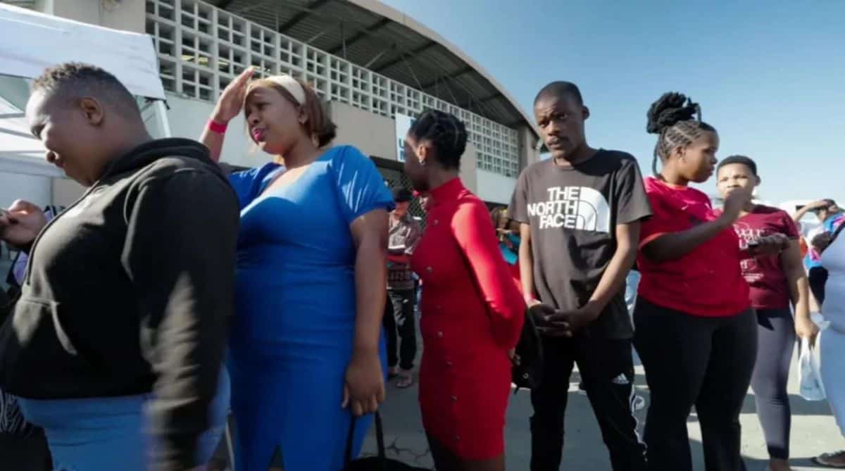 Young entrepreneurs waiting in line at startup event in Africa.