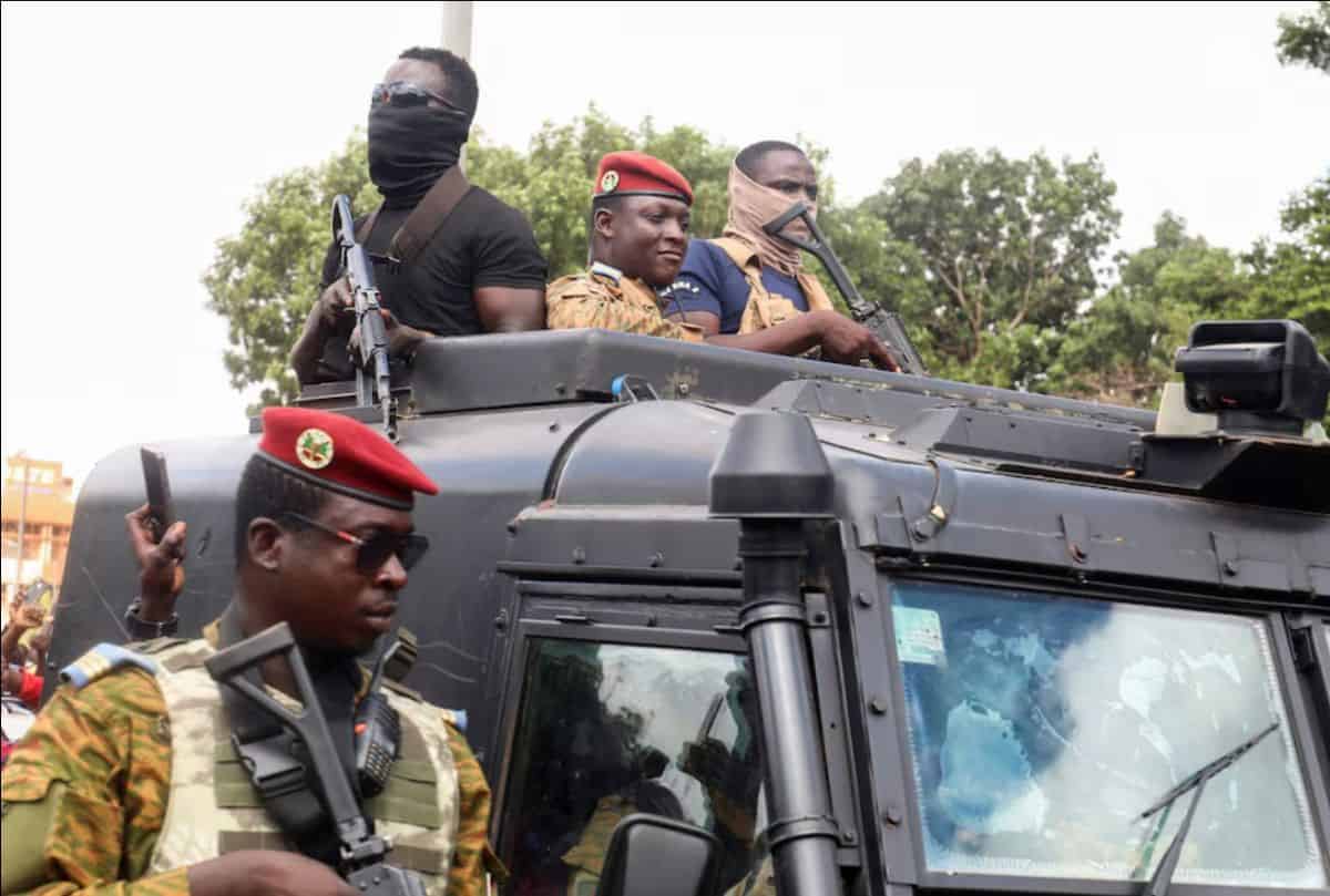 Mozambique military personnel in a vehicle during park restoration efforts.