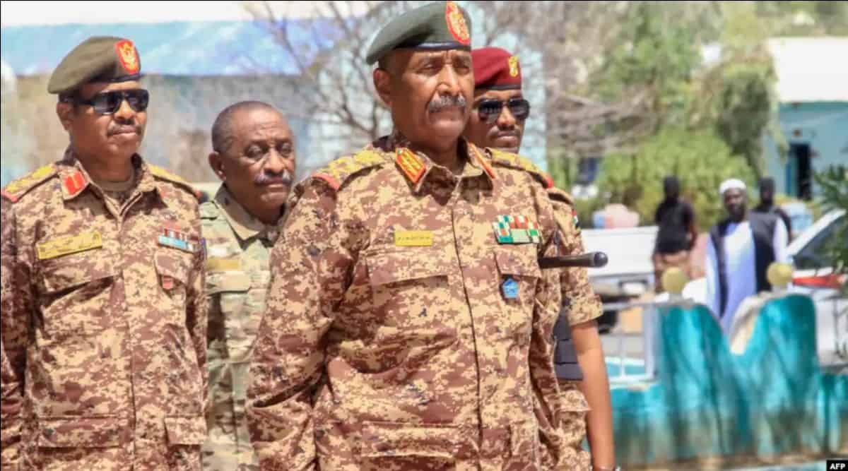 African military officials in camouflage uniforms during a formal event.