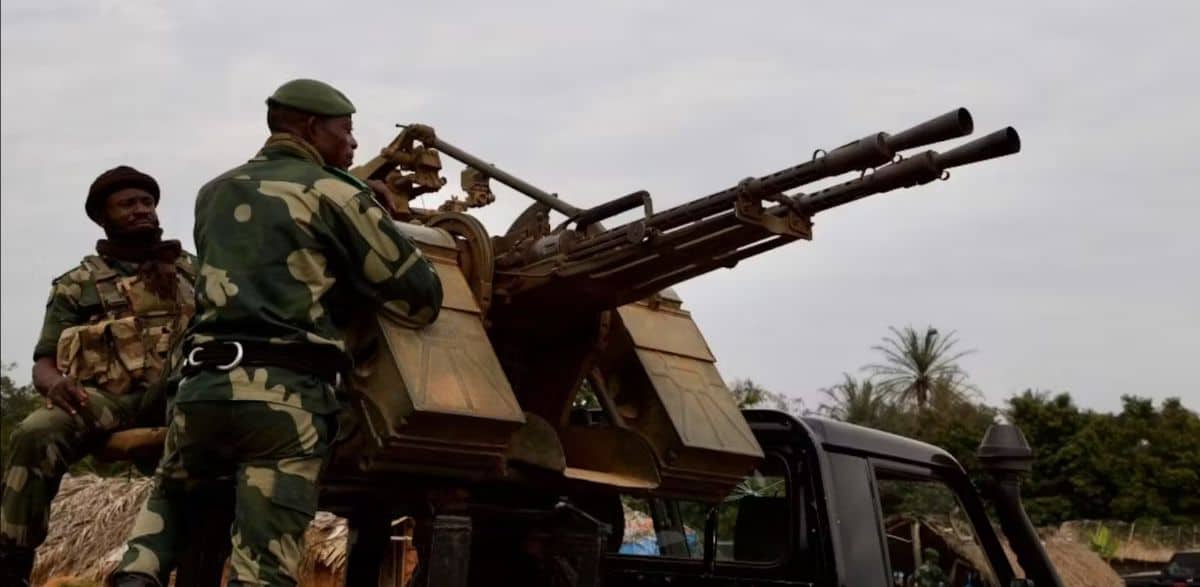 Ugandan soldiers operating a mounted military weapon during the DRC conflict.