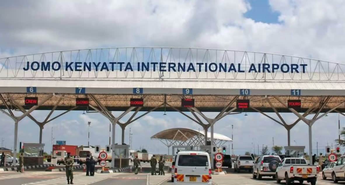 Jomo Kenyatta International Airport entrance in Nairobi, Kenya, with travelers and vehicles at the t.