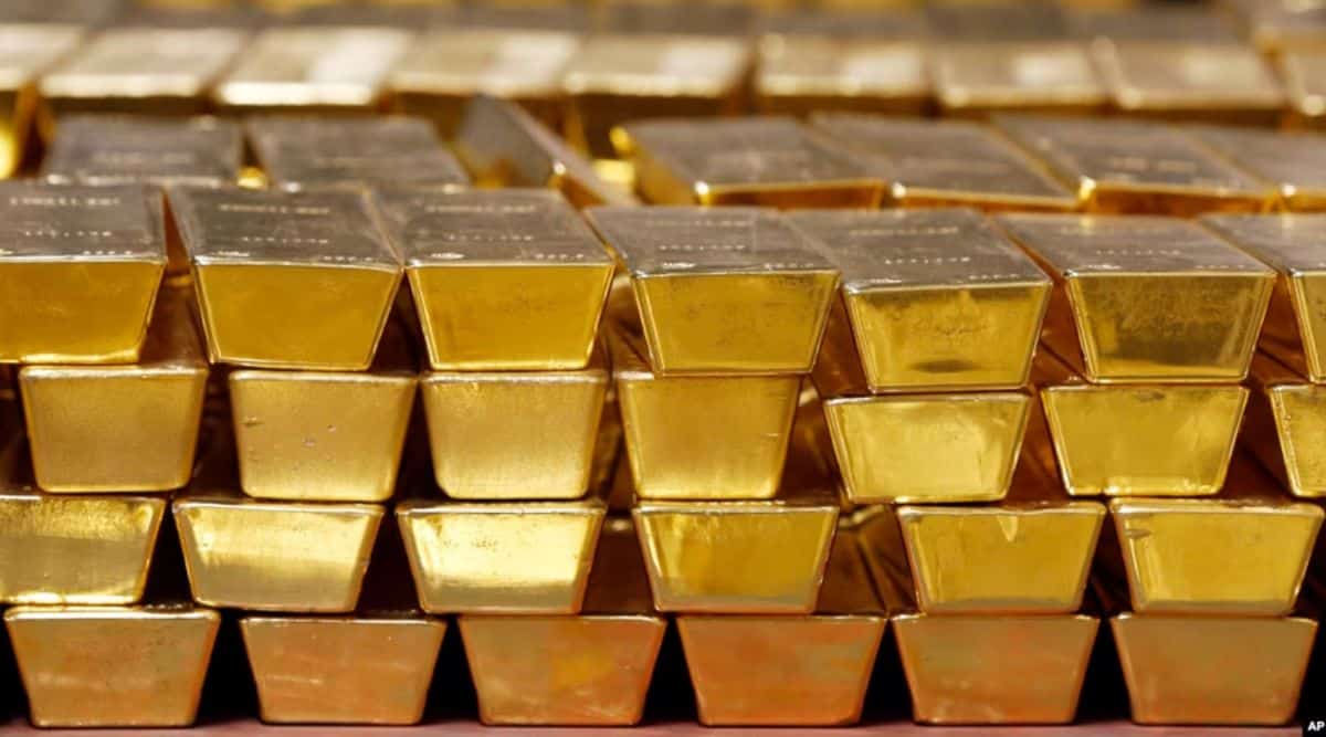 Shiny gold bars stacked in a secure vault, symbolizing wealth and precious metal investment.