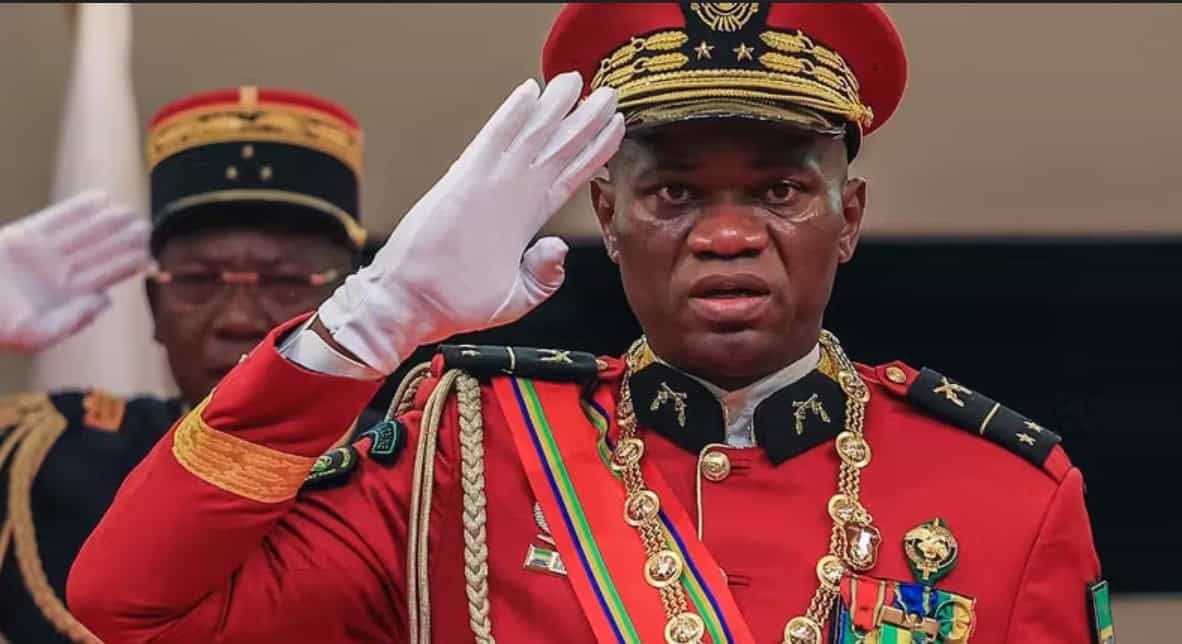 A South African military officer in uniform salutes during a formal event.