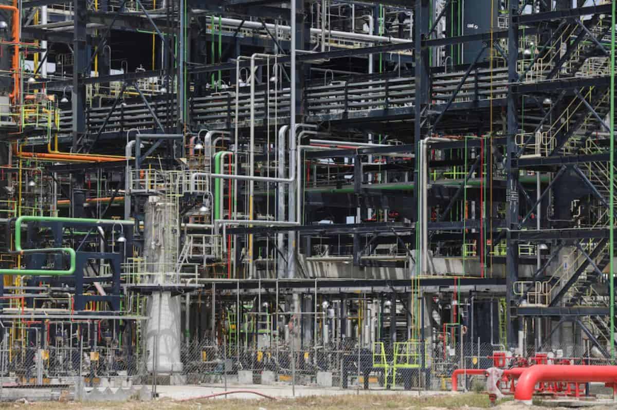 Industrial oil refinery with complex piping and processing units.