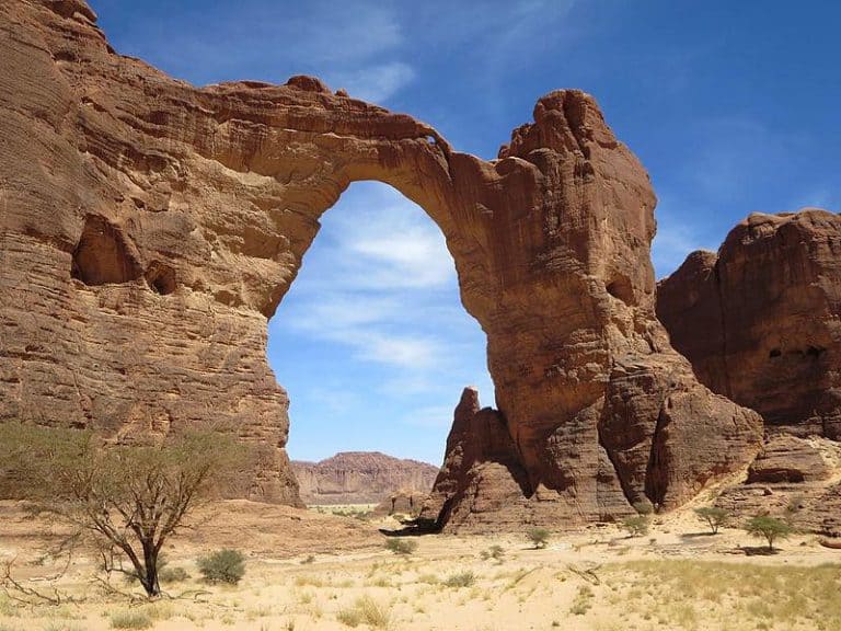 Iconic desert rock arch in Africa's Sahara with striking natural beauty.