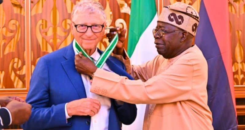 Celebration of African leaders with medals and flags at a formal event.