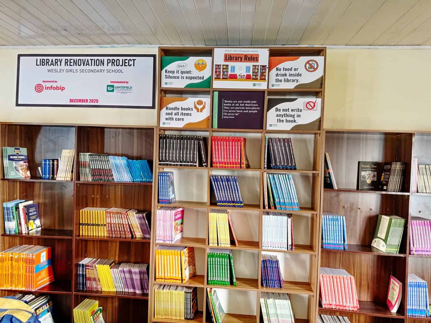 Bookshelves filled with colorful educational books in a school library.