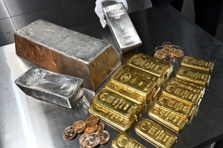 Gold and silver bullion bars with coins, symbolizing precious metals trading and market fluctuations.