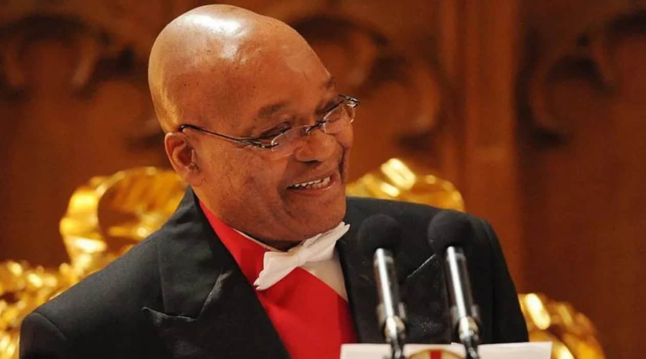 Jacob Zuma speaking at a formal event, highlighting political discussions.