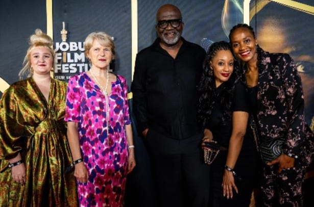 Group of diverse filmmakers and attendees celebrating at Johannesburg Film Festival.