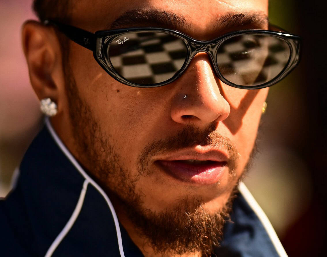 Close-up of Lewis Hamilton wearing sunglasses at African Grand Prix event.