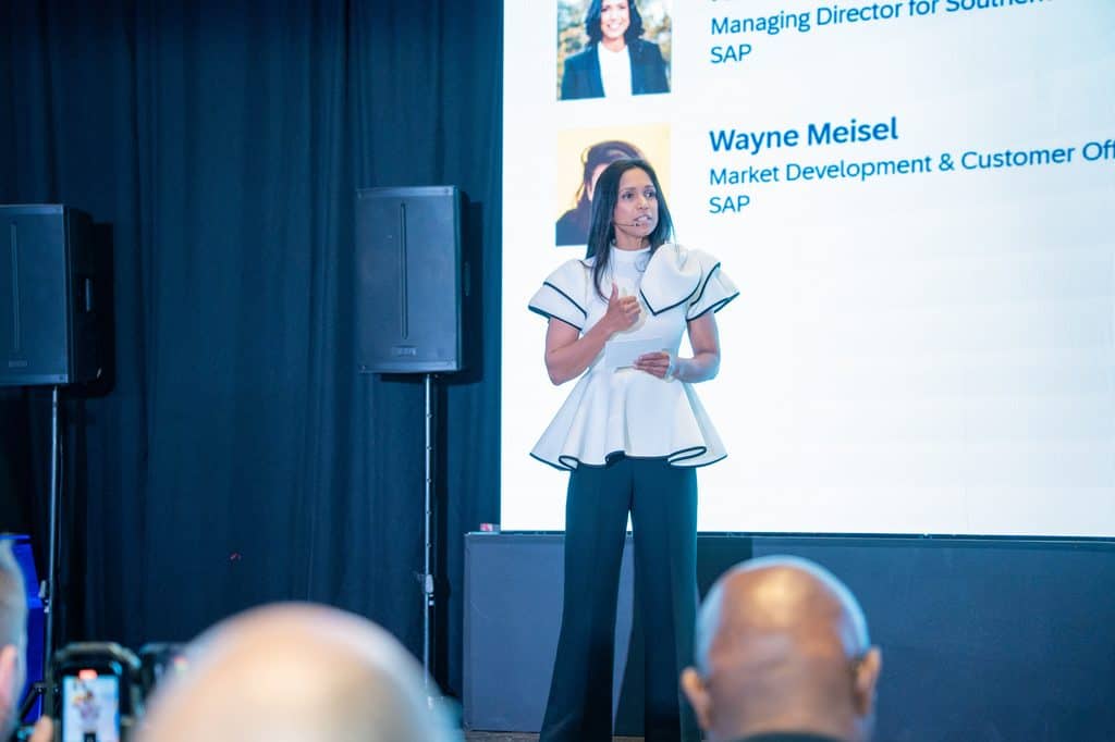 AI conference speaker presenting on business AI agents and digital transformation.