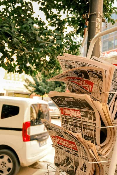 Newspapers and magazines displayed on a street stand, highlighting the role of traditional media in.