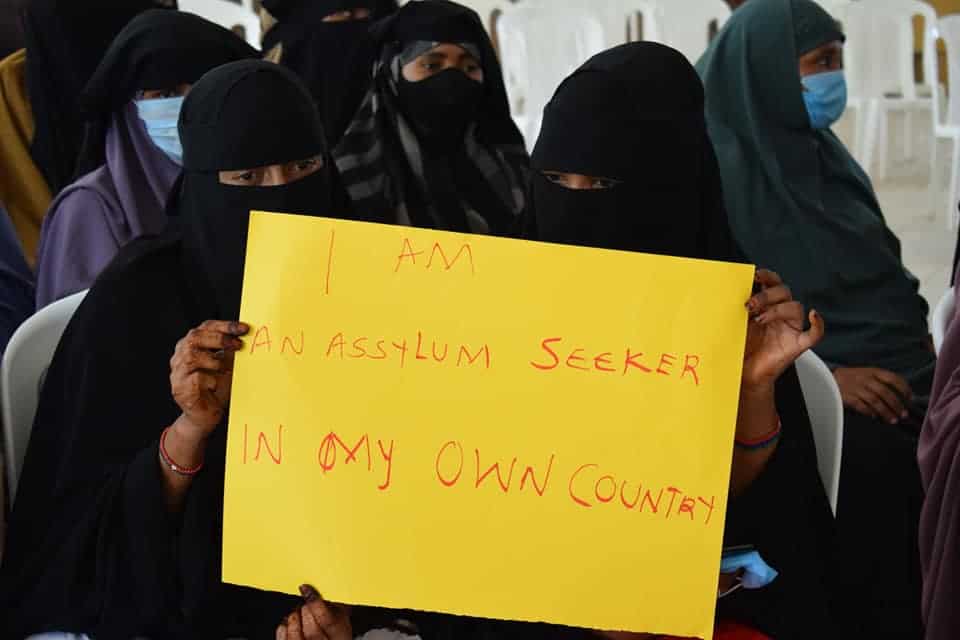Kenyan Somali women holding a protest sign about statelessness.