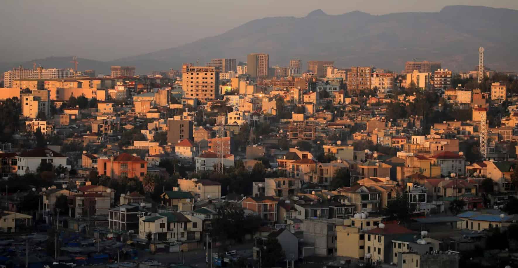 Urban cityscape in Africa with buildings and mountains in the background.