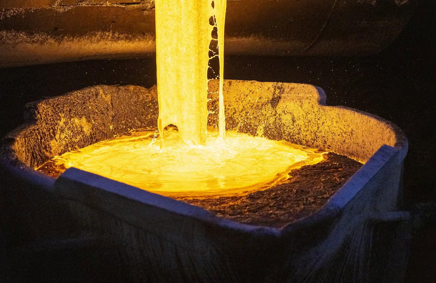 Gold pouring into a mold at an African mining site.