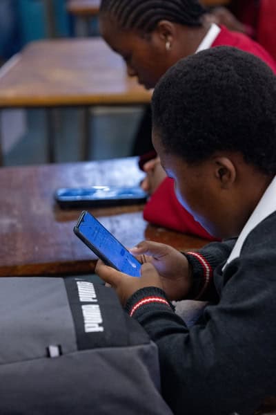 Students using smartphones for blended learning at Engen Maths & Science Schools.