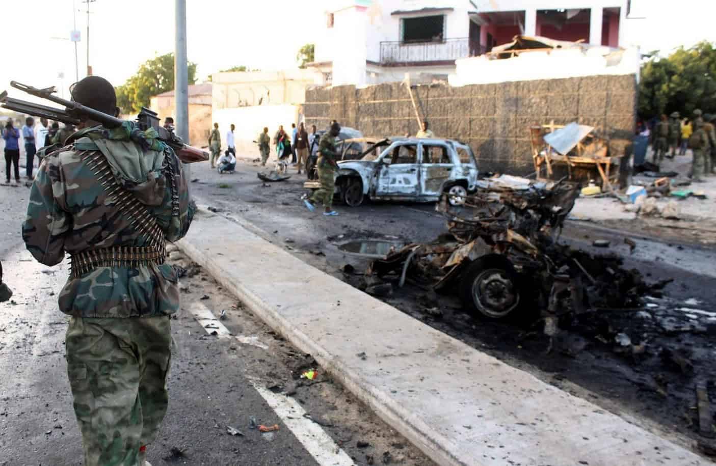 Explosion aftermath with armed soldier patrolling the scene.